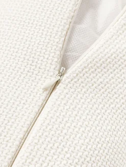 Cuscino rullo in bouclé con bordino Aya