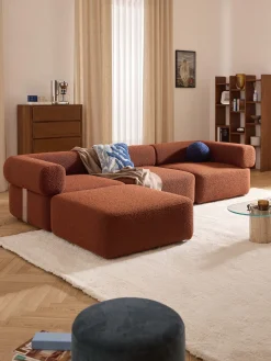 Divano componibile 4 posti in bouclé con poggiapiedi Anton (sinistra/destra)