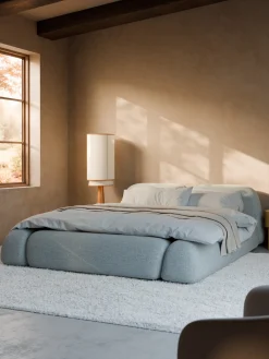Letto imbottito in bouclé con contenitore Wolke