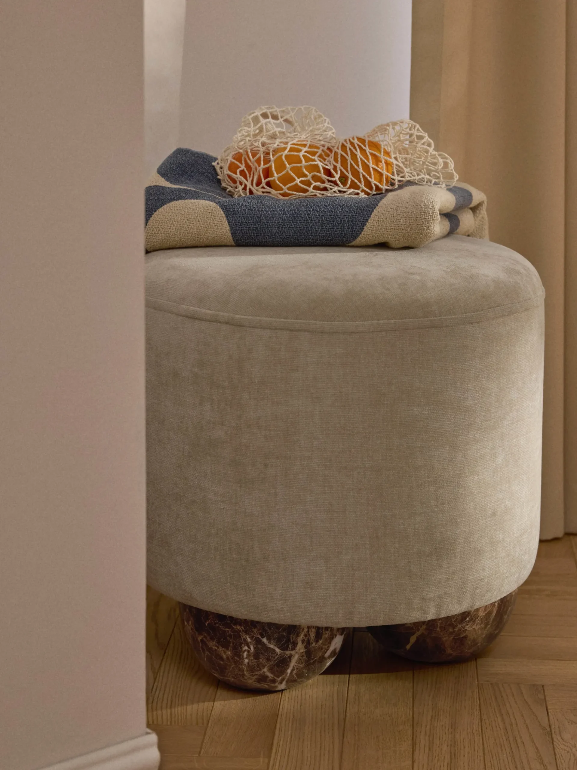 Pouf imbottito con piedini a sfera effetto marmo Lino